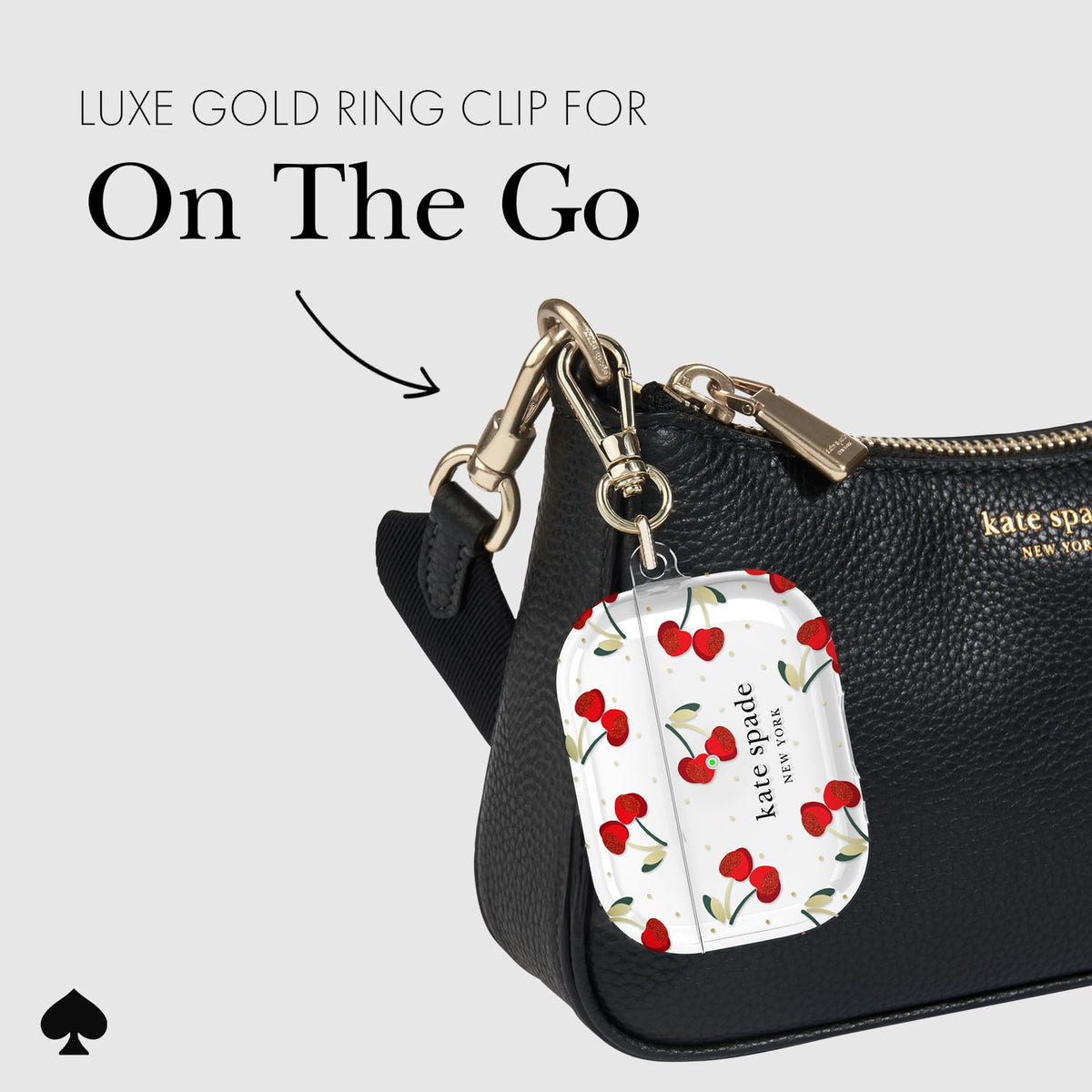 kate spade new york Cherry Dot held in hand showing compact portable size