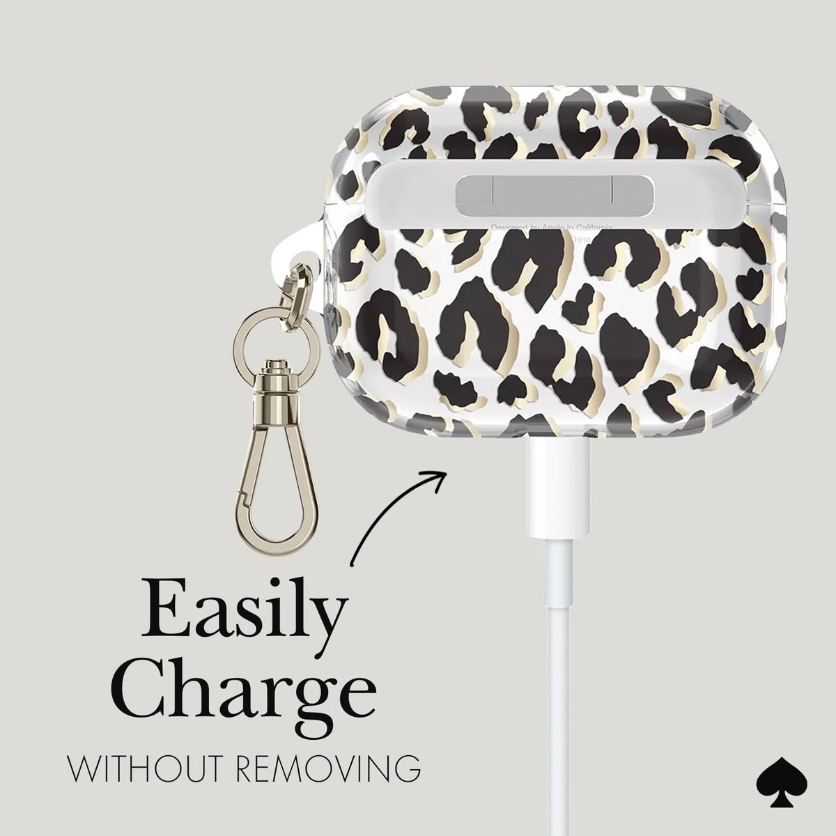 kate spade new york attached to bag via gold keychain for easy access