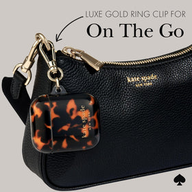 kate spade new york AirPods case attached to bag with keychain ring