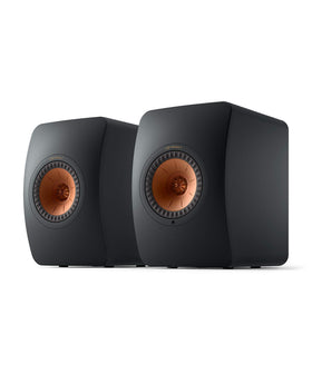 KEF LS50 Wireless II front view in carbon black delivering immersive stereo in a modern living room.