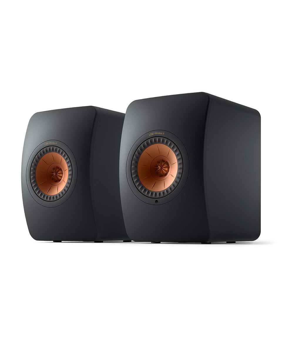 KEF LS50 Wireless II front view in carbon black delivering immersive stereo in a modern living room.