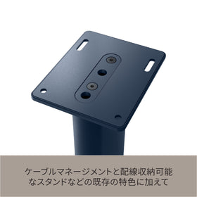 KEF S2 Royal Blue floor protector discs shielding floors during setup.