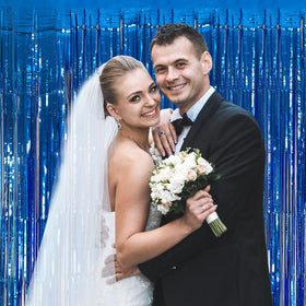 K.E.J. foil fringe backdrop adds glamour without permanent fixtures.