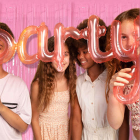 K.E.J. pink foil curtain backdrop with balloons elevating celebrations