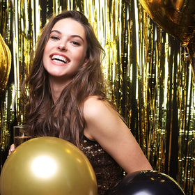 K.E.J. fringe curtain backdrop amplifies lighting and invites guests to pose for photos.