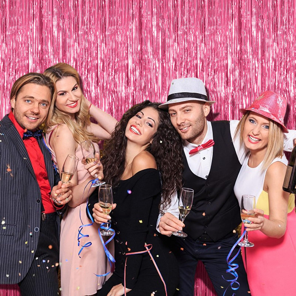 K.E.J. pink metallic tinsel curtain creates shimmering photo booth backdrop.