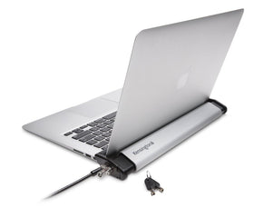 Kensington Laptop Locking Station 2.0 securing a MacBook on a desk for security.