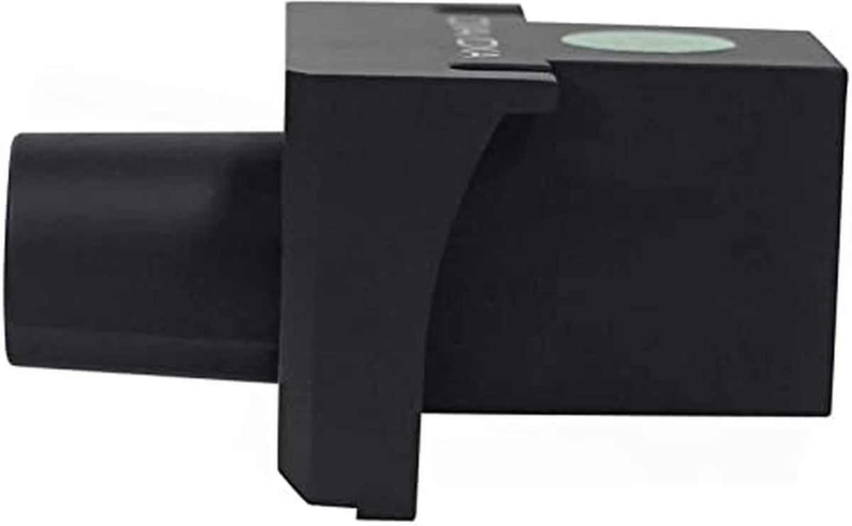 KICKER remote beside a hand and coin to show scale and compact footprint