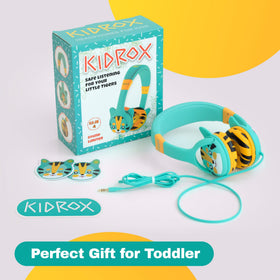 Kidrox child wearing headphones on plane for quiet travel