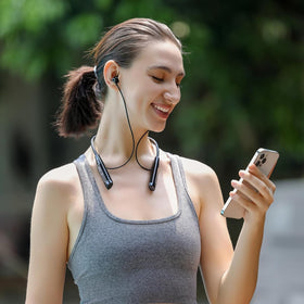 Kinobo earbuds with water splashes illustrating IPX7 protection for active use benefit