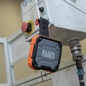 Klein Tools speaker mounted on conduit demonstrating stable hands-free placement