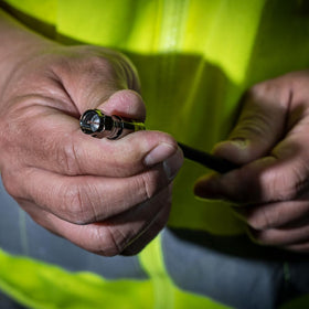 Klein Tools connector being compressed on coax demonstrating faster, secure install