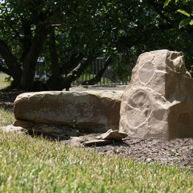 Klipsch AWR-650-SM sandstone outdoor rock speaker side view blends in yet sounds clear.