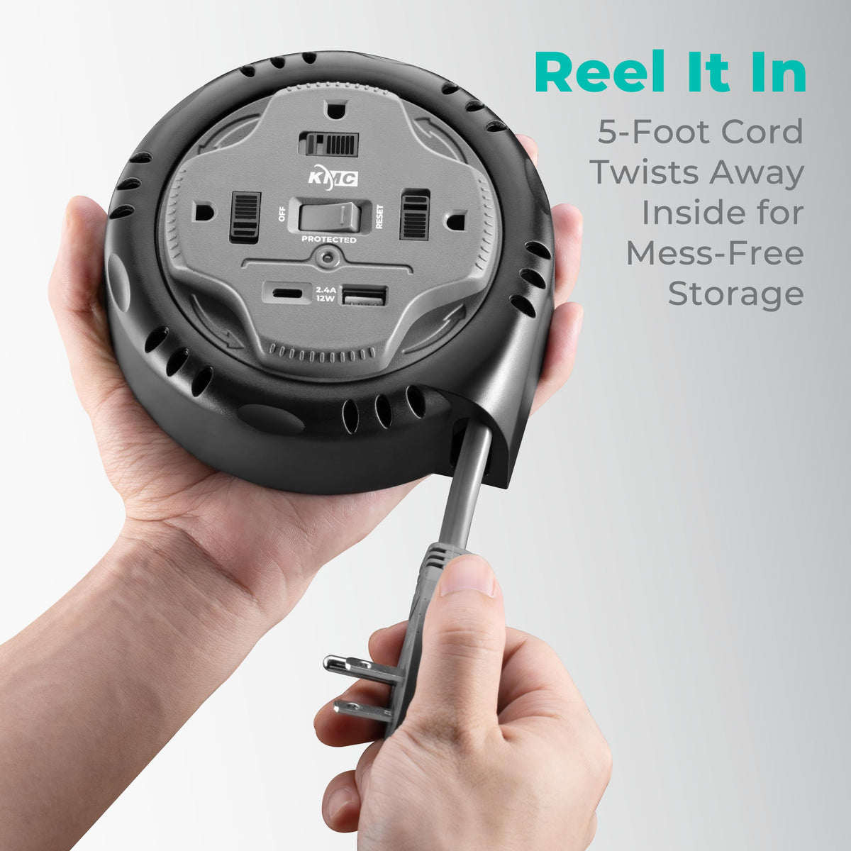 KMC gray compact reel fits beside furniture for discreet power access.