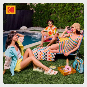 KODAK camera held in hand for scale, pocket-sized portability benefit