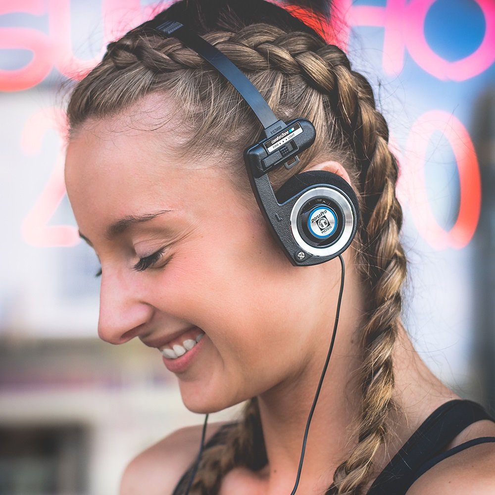 Koss Porta Pro worn by commuter on a train showing portability and on-the-go listening