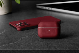 Latercase crimson beside keys showing thin 6g profile and portability benefit