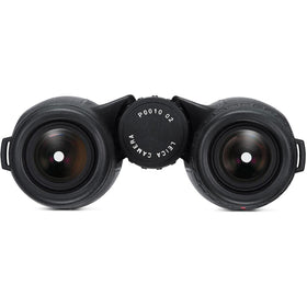 Binocular in use with a steady grip on outdoor scenery.
