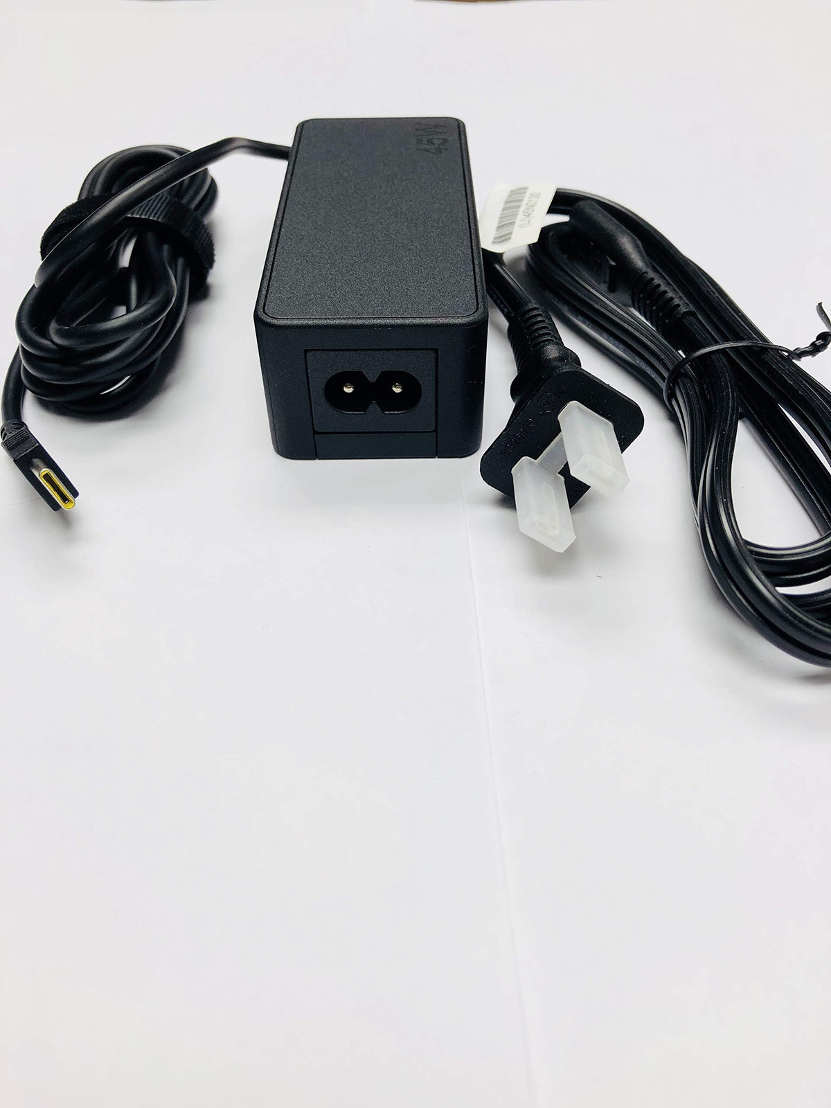 Lenovo 45W USB-C AC adapter in use, powering a ThinkPad via USB-C charging.