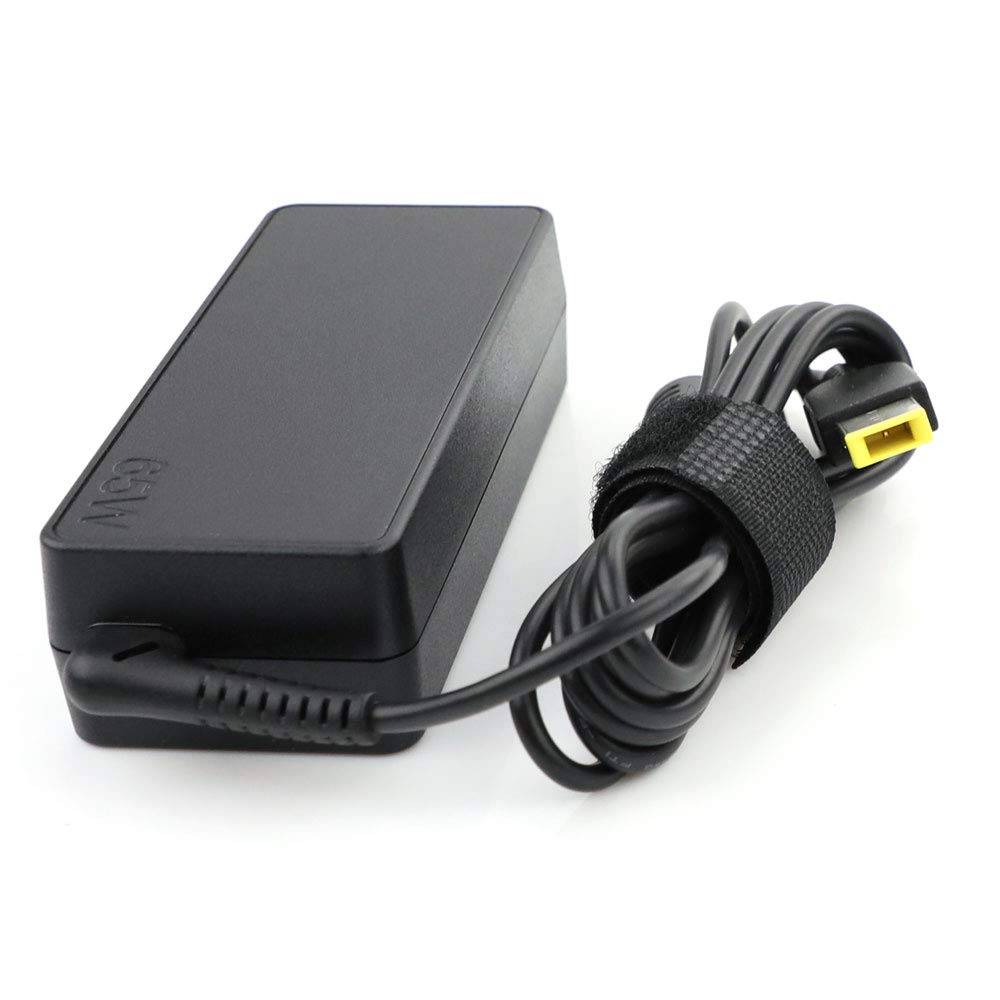 Lenovo adapter on a travel-ready desk setup near a ThinkPad.