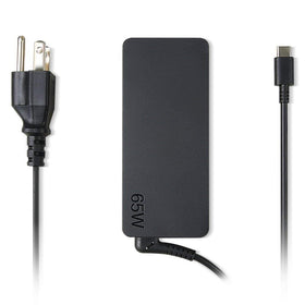 Lenovo charger beside laptop showing plug-and-play simplicity for travel.