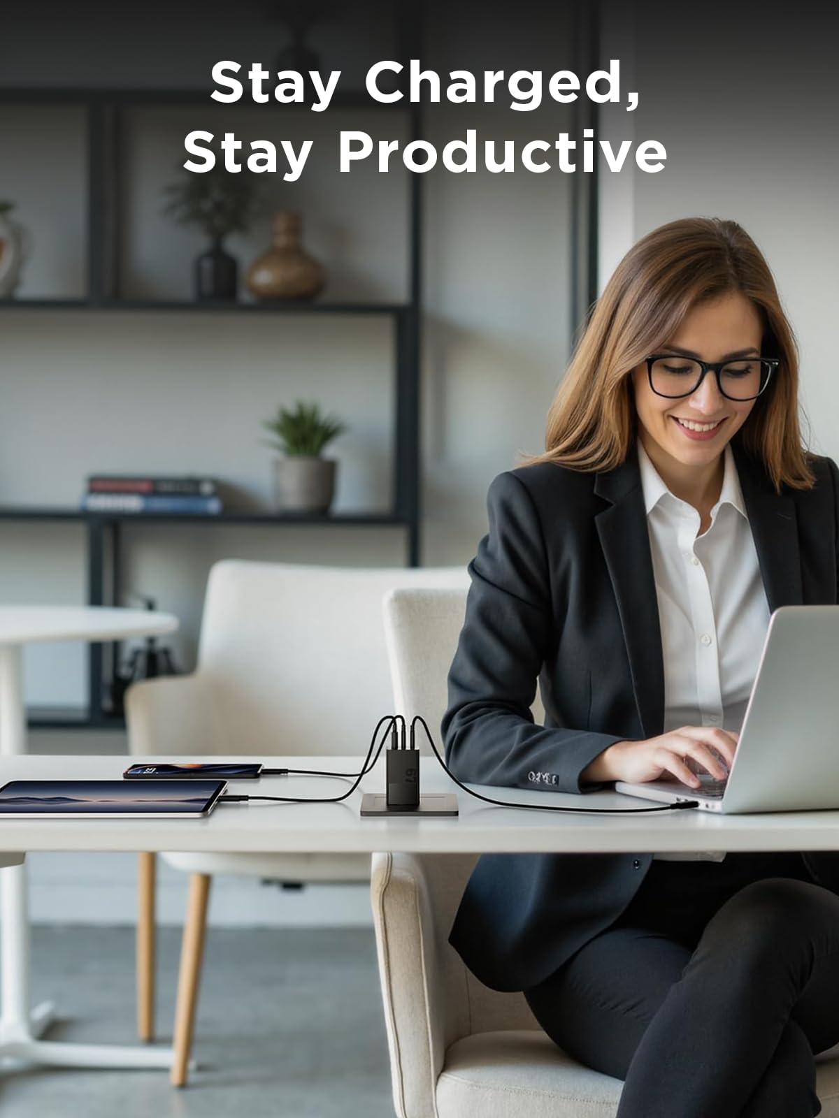 Lenovo 67W charging laptop and phone on desk for efficient multi-device power