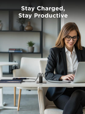Lenovo 67W charging laptop and phone on desk for efficient multi-device power