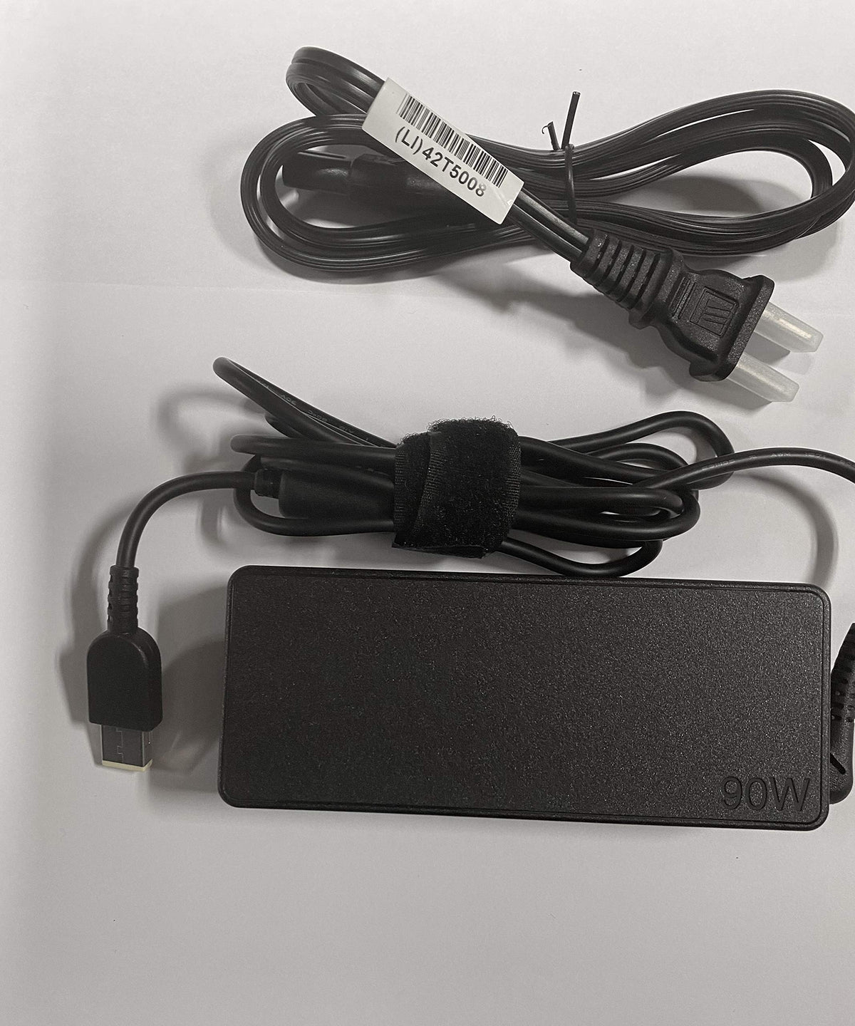 Lenovo adapter includes power cord for convenient charging setup.