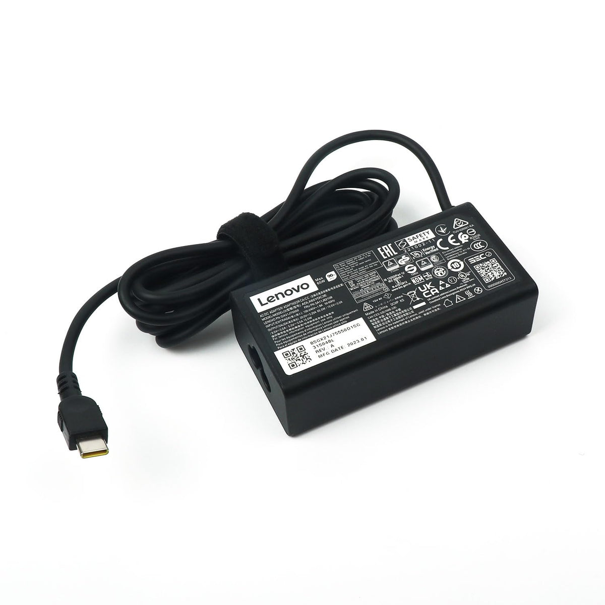 Lenovo adapter held in hand to show scale and travel-friendly portability