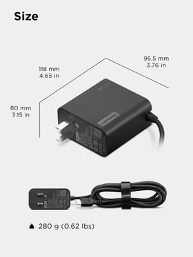 Lenovo 65W charger beside passport and bag showing ideal travel portability