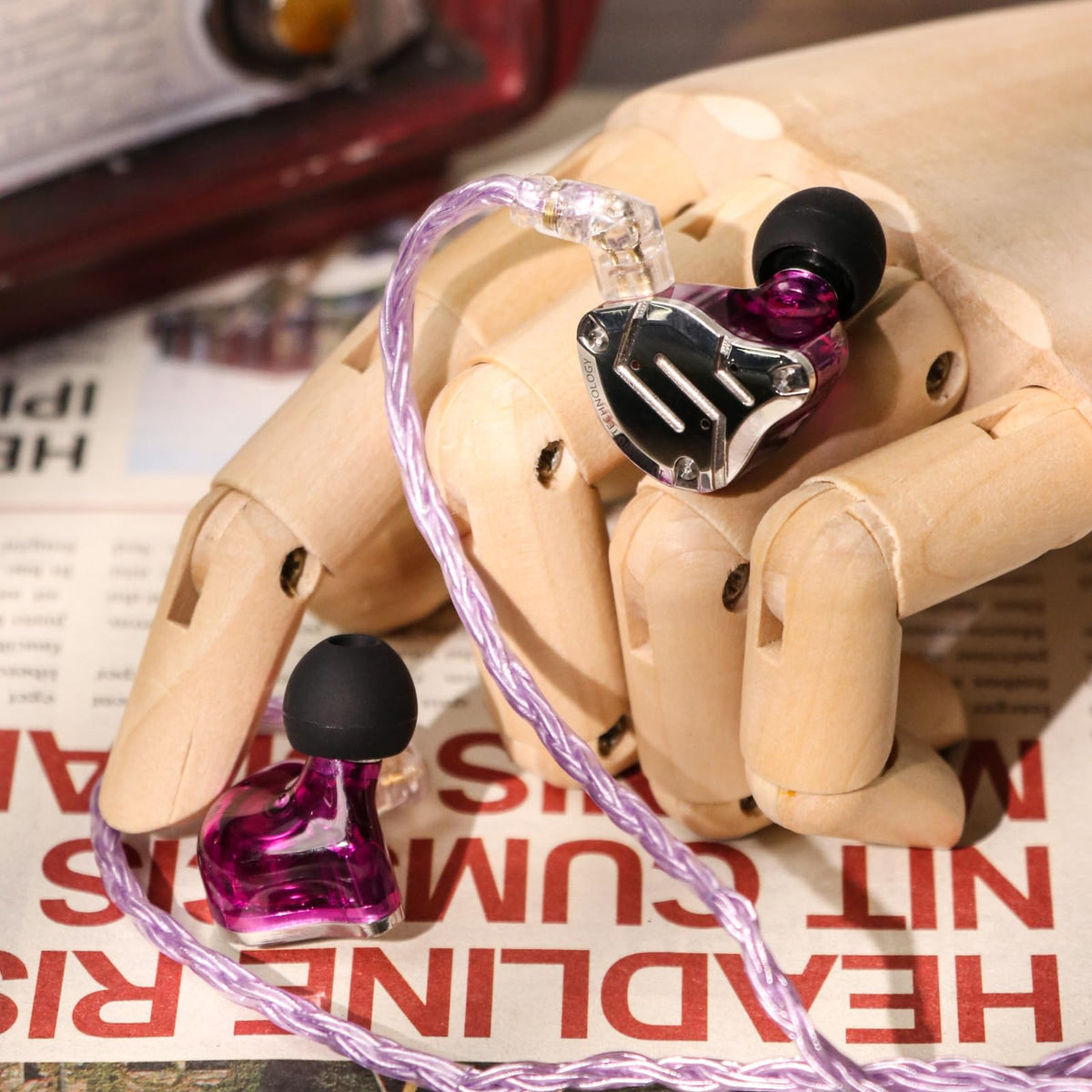 Linsoul earbuds next to coin for size comparison showing compact, pocketable design