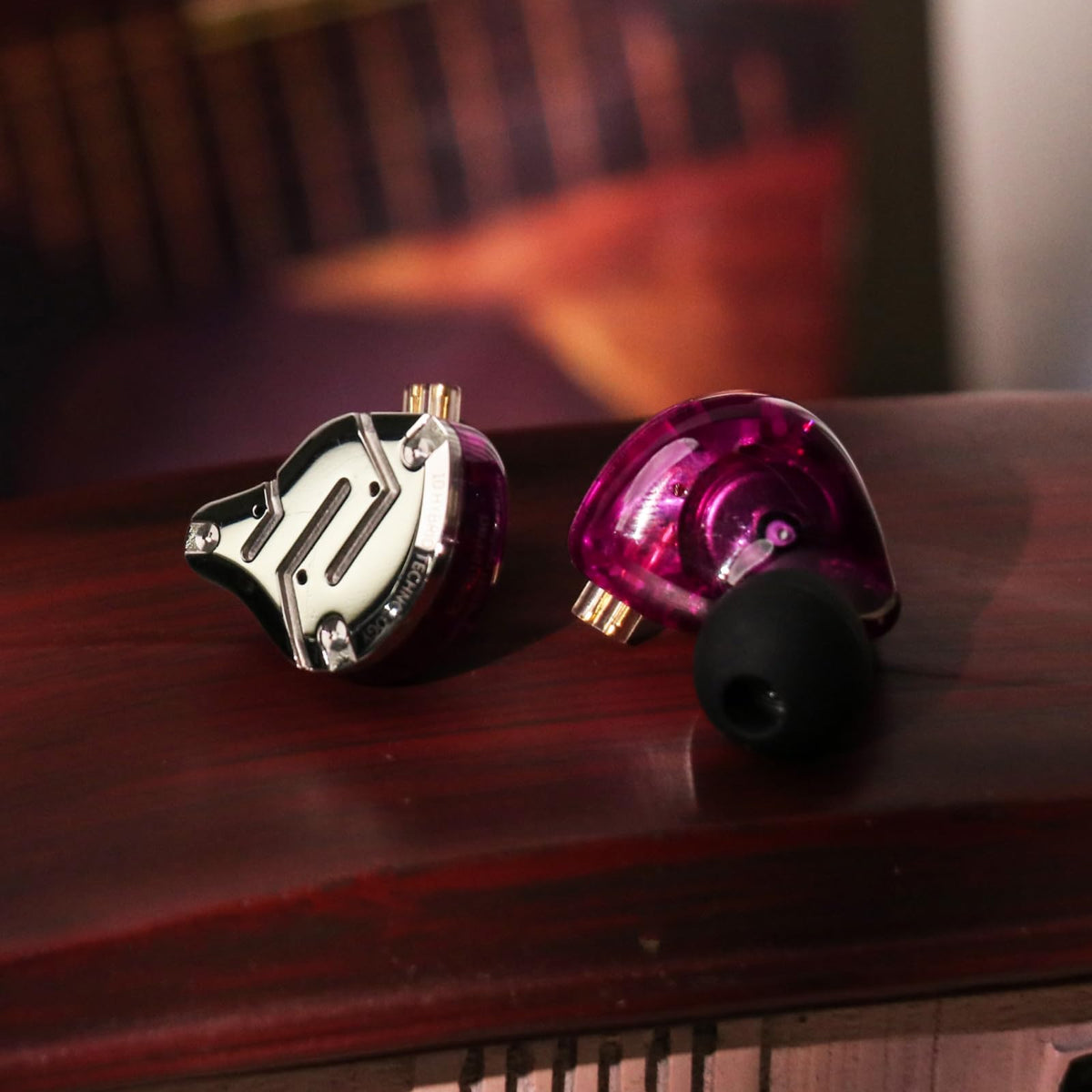 Linsoul earbuds next to a coin for size scale showing compact portability benefit