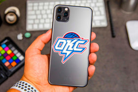 LIONSBRIDGE Oklahoma basketball stickers on skateboard, bold designs for street flair.