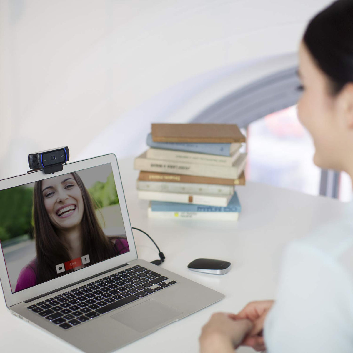 Logitech C920 in a home office lifestyle shot showing usable streaming setup benefit improved meetings
