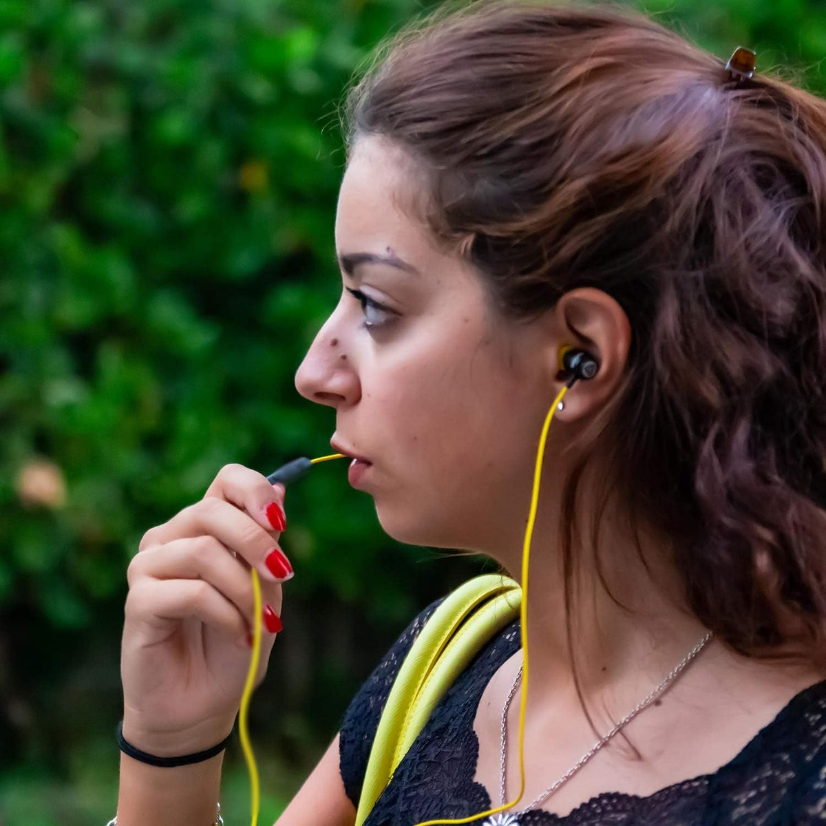 LUDOS earbuds plugged into iPhone for low-latency listening