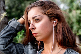 LUDOS Clamor pink earbuds resting in case illustrate portable storage and travel readiness