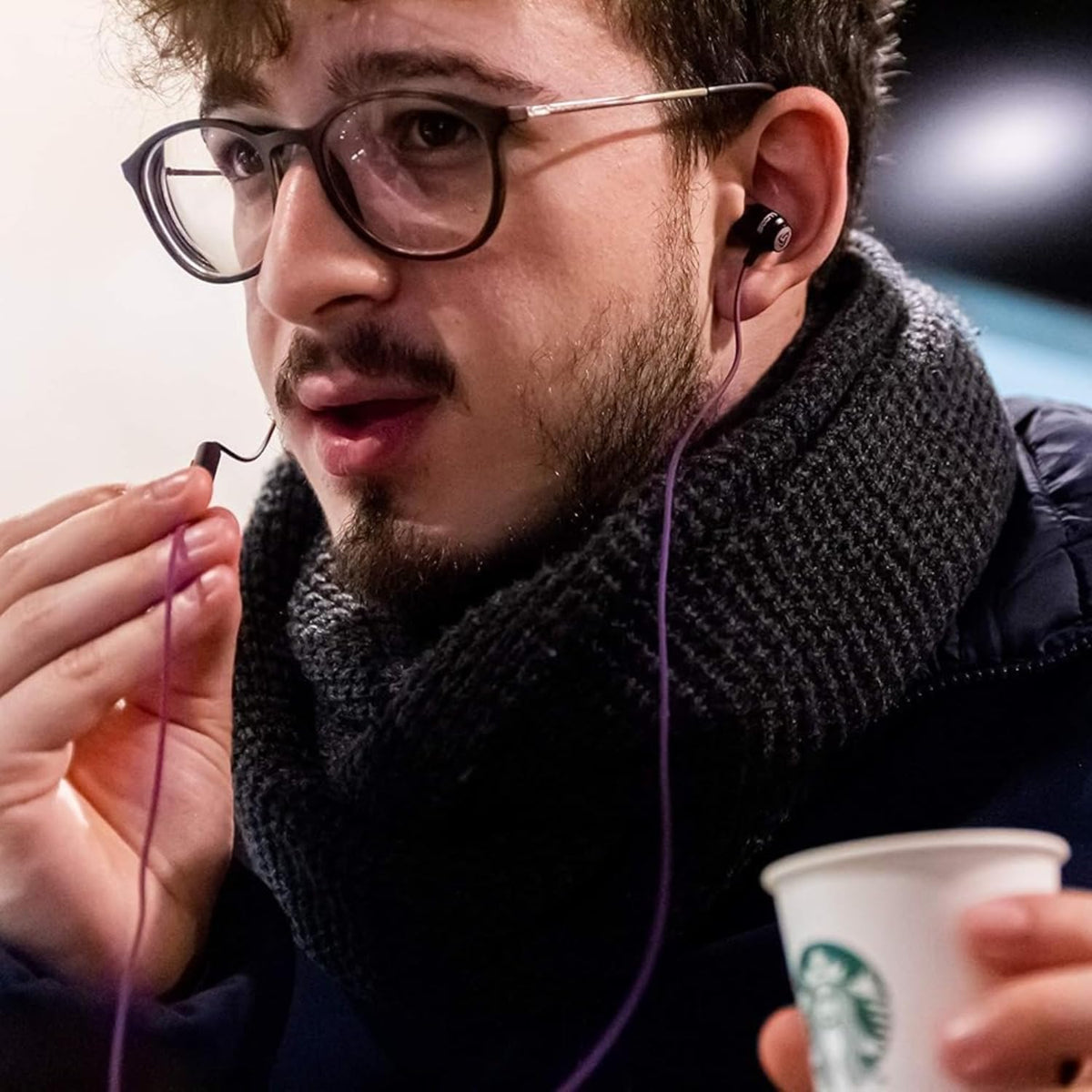 LUDOS Clamor plugged into iPhone showing USB-C connection and reliable audio