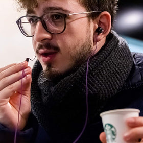 LUDOS Clamor plugged into iPhone showing USB-C connection and reliable audio