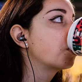 LUDOS Clamor earbuds partially in a pocket showing portable, tangle‑resistant everyday carry