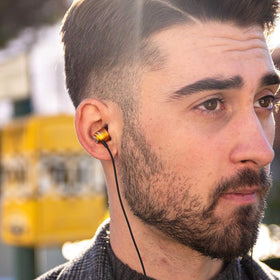 LUDOS Clamor earbuds plugged into smartphone in hand for clear calls and audio convenience