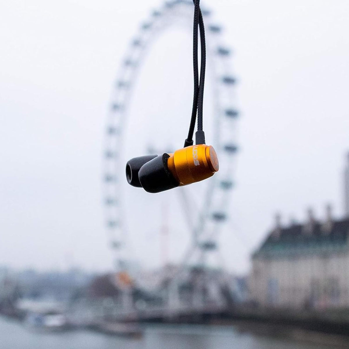 LUDOS Clamor earbuds on a commuter bench illustrating reliable audio on the go