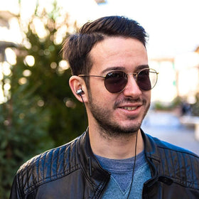 LUDOS Clamor used by a commuter wearing a backpack to show reliable travel audio