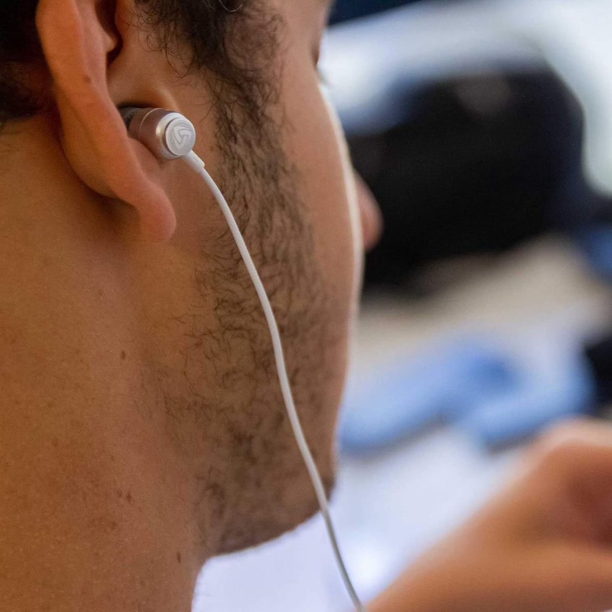 LUDOS Clamor worn by commuter on city transit showing comfort and reliable audio benefit