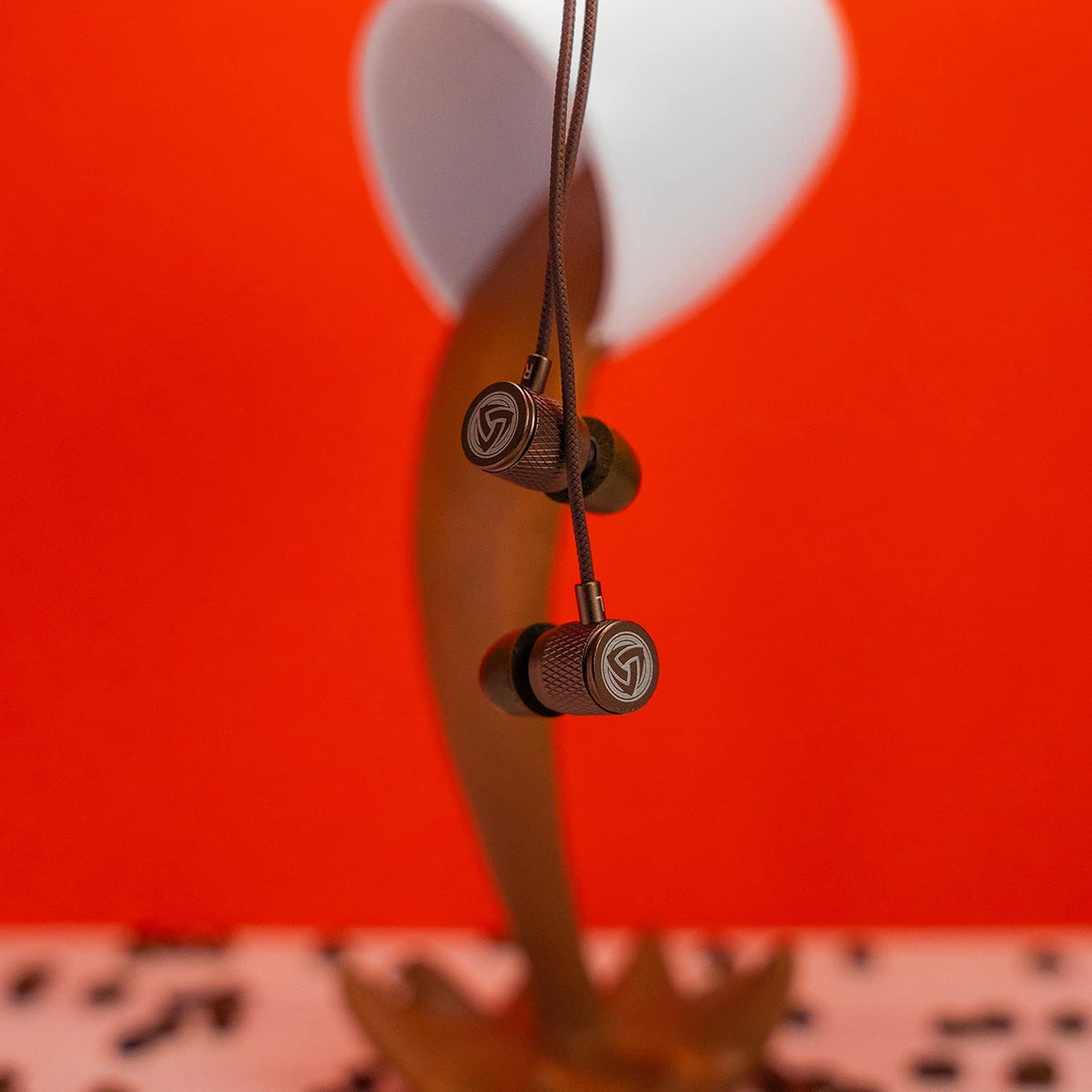 LUDOS Ultra wired earbuds brown in-ear fit shows secure wear.