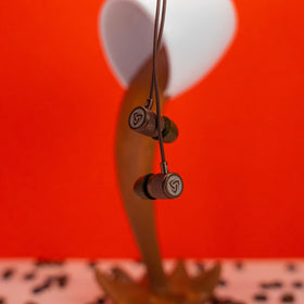 LUDOS Ultra wired earbuds brown in-ear fit shows secure wear.