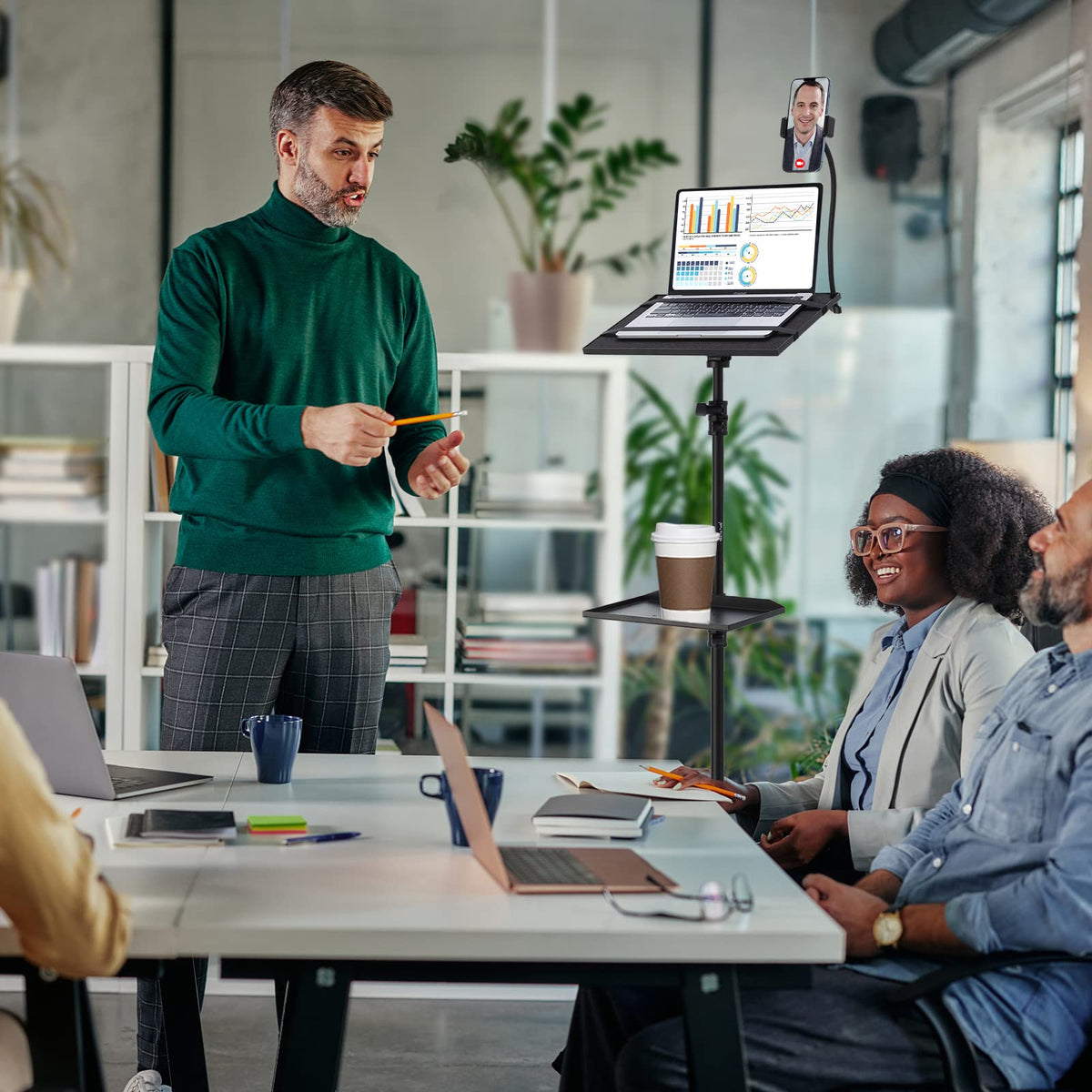 Lusweimi stand next to laptop showing scale and workspace versatility