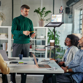 Lusweimi stand next to laptop showing scale and workspace versatility
