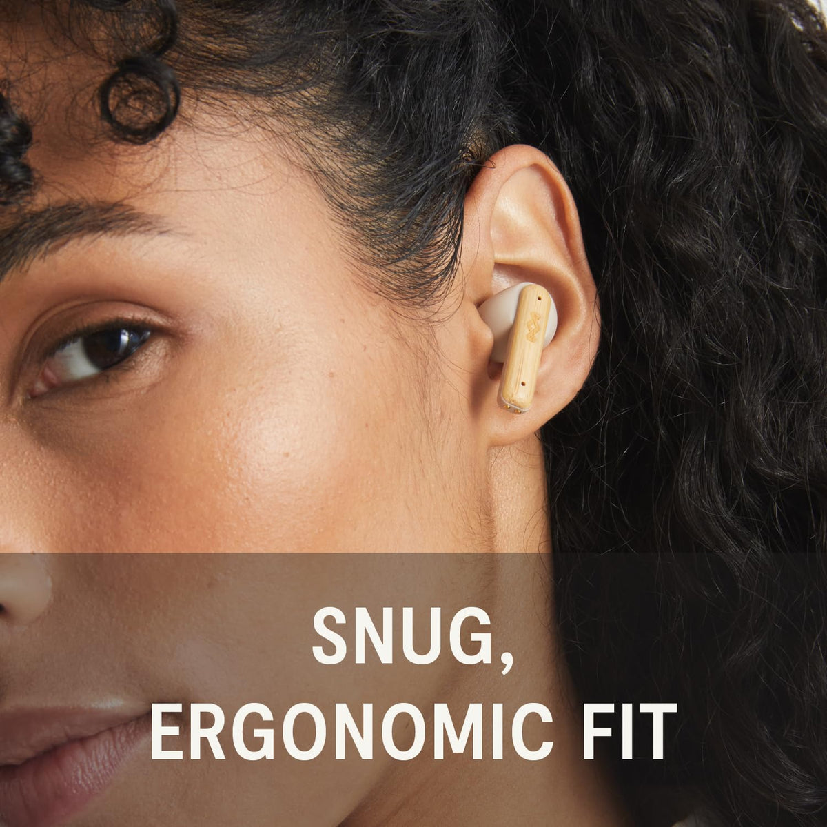 House of Marley earbuds in ear outdoors showing stable fit and active use