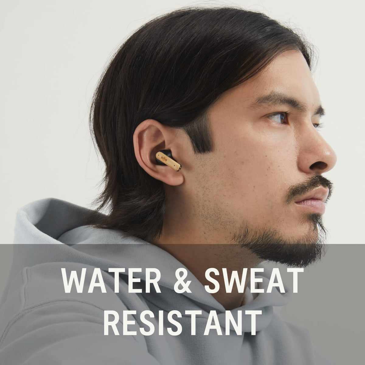 House of Marley earbuds in hand showing size and portability for travel convenience