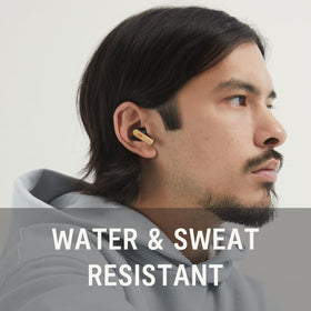 House of Marley earbuds in hand showing size and portability for travel convenience